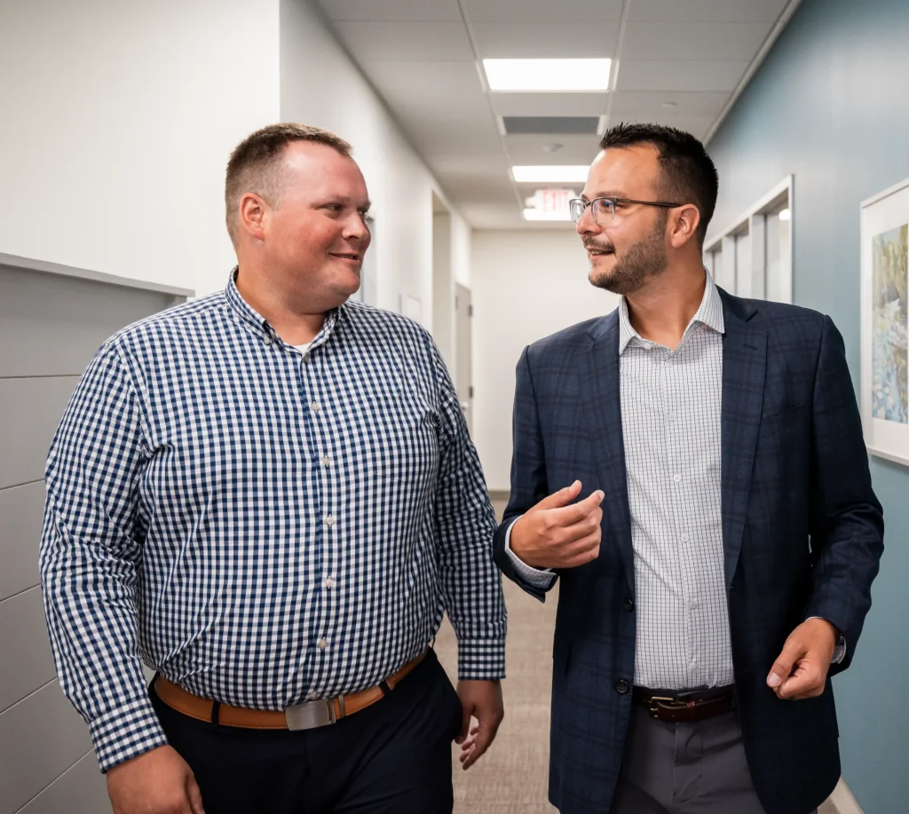 Conversation with advisor at H&S Companies in hallway while walking
