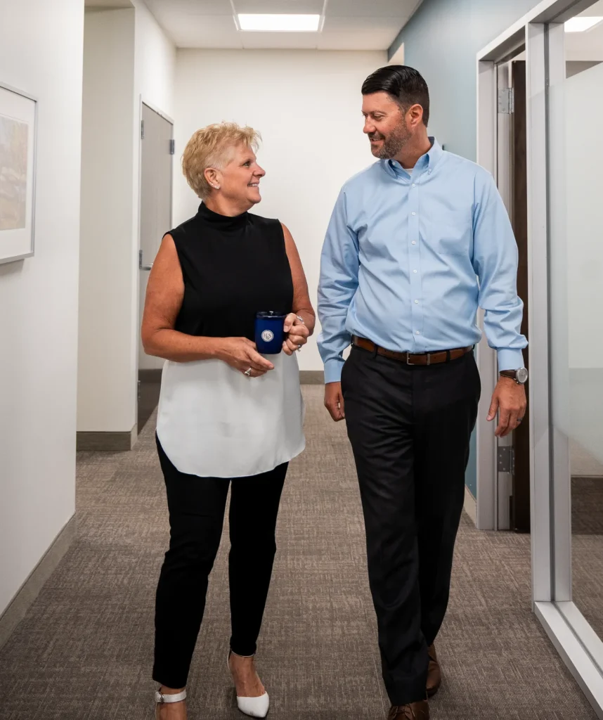 Conversation with advisor at H&S Companies in hallway while walking