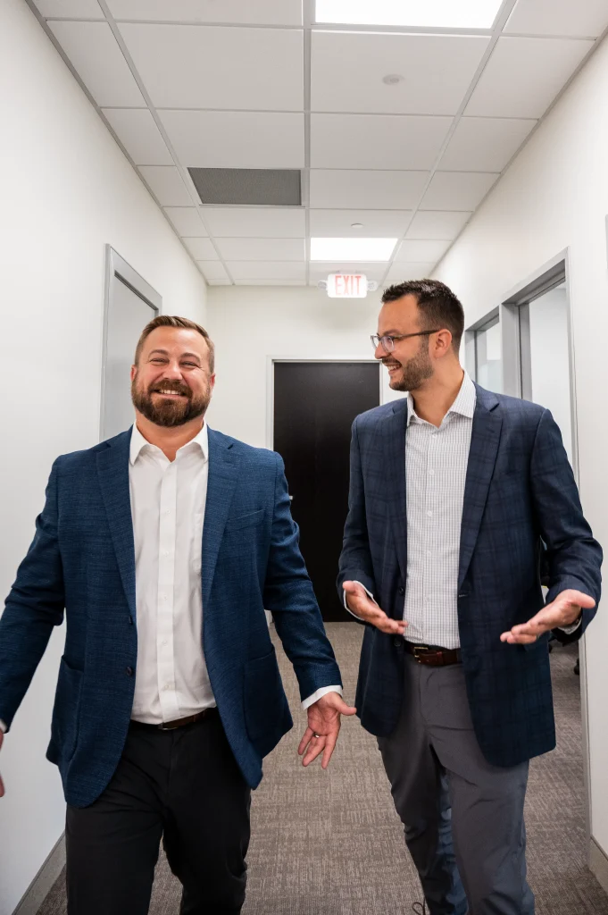Conversation with advisor at H&S Companies in hallway while walking